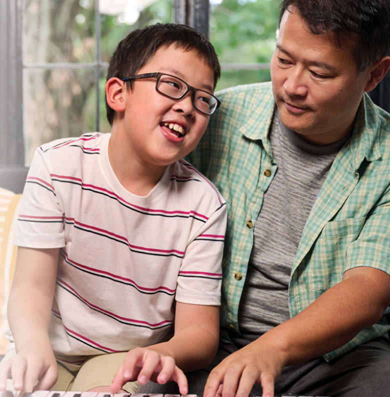 Sam, a 10-year-old living with NF1 PN, smiling with his dad
